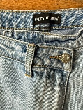 Pretty Little Thing Asymmetrical Waist size 4 light wash jeans